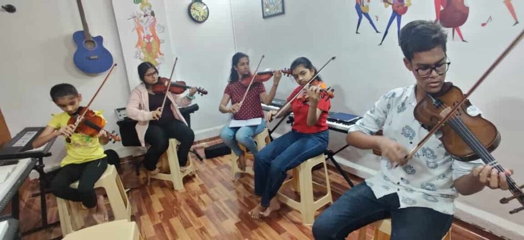 Student playing violin in Divine Muzic Academy